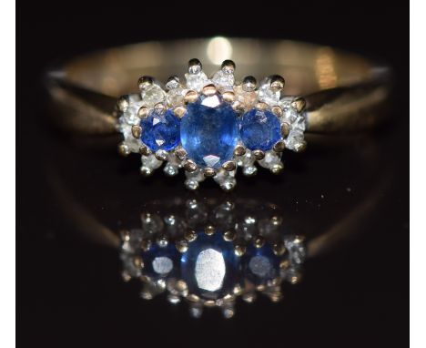 A 9ct gold ring set with sapphires surrounded by diamonds, 2.2g, size M