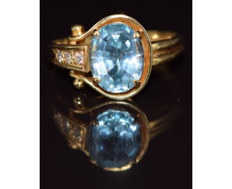 An 18k gold ring set with an oval cut topaz and diamonds, size L/M, 3.6g