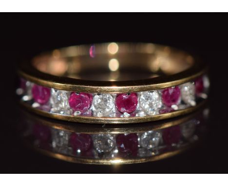 A 10k gold half eternity ring set with alternating rubies and diamonds, 2.6g, size L