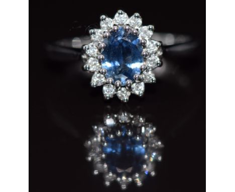 A 9ct white gold ring set with a sapphire of approximately 0.8ct surrounded by diamonds, 3.3g, size N