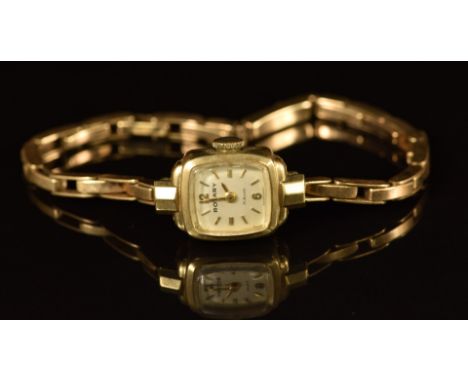 Rotary 9ct gold ladies wristwatch with gold hands and hour markers, silver dial and 21 jewel movement, on 9ct gold bracelet, 