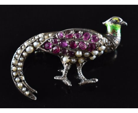 A silver brooch in the form of a pheasant set with rubies, seed pearls and enamel, width 3.2cm