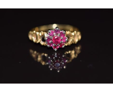 An 18ct gold ring set with a cluster of rubies, 2.5g, size K