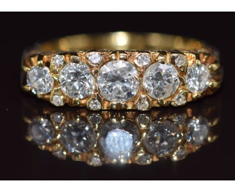 An 18ct gold ring set with thirteen diamonds, the centre diamond approximately 0.4ct, 5.6g, size P