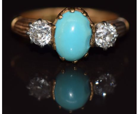 An 18ct gold ring set with a turquoise cabochon and two old cut diamonds, each approximately 0.25ct, 4.6g, size N