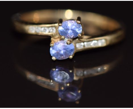 A 14k gold ring set with two tanzanites and diamonds, 1.8g, size L