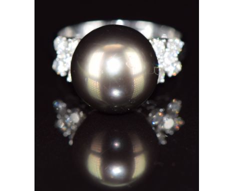 An 18ct white gold ring set with a 14ct black South Sea pearl and five diamonds to each shoulder, total diamond weight 0.42ct