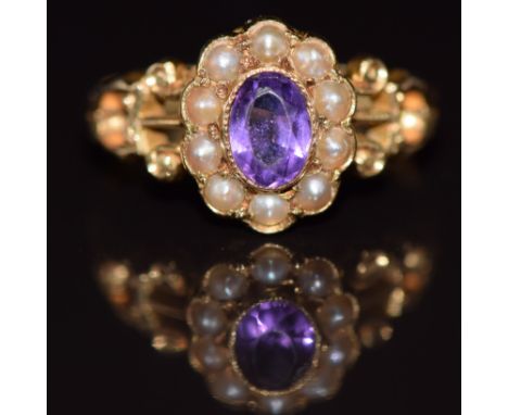 An 18ct gold ring set with an oval cut amethyst surrounded by seed pearls, 3.1g, size L/M