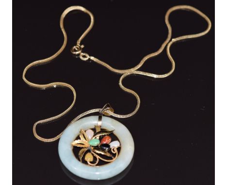 A 14k gold pendant set with a jade disc with a gold foliate design to the centre set with jade cabochons (11.8g) on a 14k gol