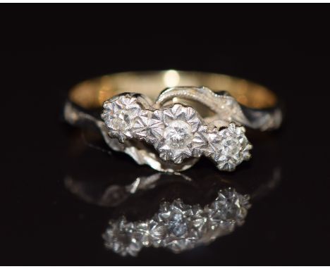 An 18ct gold ring set with three diamonds in a platinum setting, 2.7g, size K