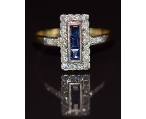 Art Deco 18ct gold ring set with three calibre cut sapphires surrounded by diamonds in a rectangular setting, 2.6g, size P