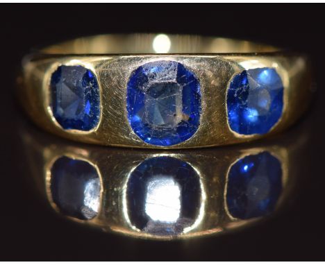 An 18ct gold ring set with three sapphires the centre stone approximately 0.7ct, 6.9g, size Q