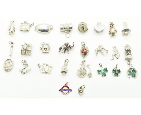 Twenty five silver charms including two enamel shamrocks by WBs, owl, elephant, boat, MG car, penguin, letter box, playing ca