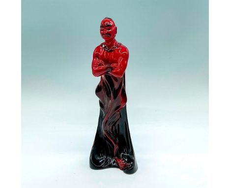 Glazed figure of a genie standing with arms crossed. Red with black accents. Lamp seen at bottom. Royal Doulton Flambe backst