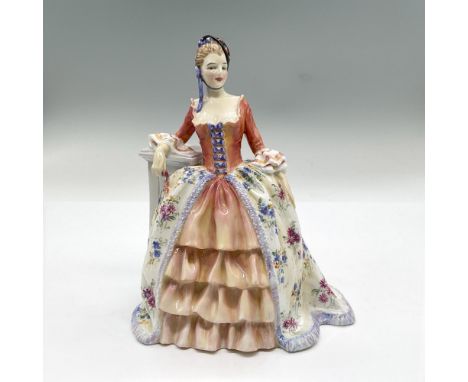 Glossy bone china figure of a lady in a dark peach dress, floral overskirt and black hat leaning on a pillar. Part of the Har