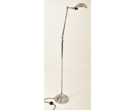 An Art Deco style 20th century chrome metal floor standard lamp. The lamp having a shell shaped shade over an adjustable thre