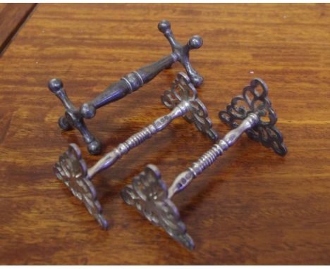 Pair of Geo lll sterling silver knife rests hallmarked London 1815 together with another knife rest