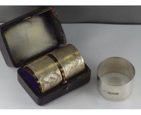 Pair of boxed sterling silver napkin rings engraved with Stork & foliage design, no silver marks, together with a single Scot