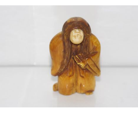 Antique Ivory netsuke of man with 2 faces height: approx 5cm. NB this item may not be exported.