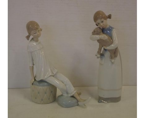 Two Lladro girl figurines one holding a lamb 22cm high, & the other reclining