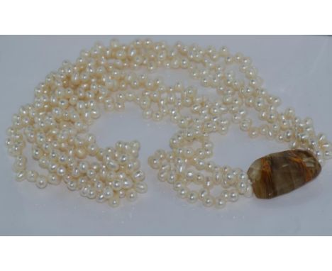 Three strand baroque pearl necklace with feature stone