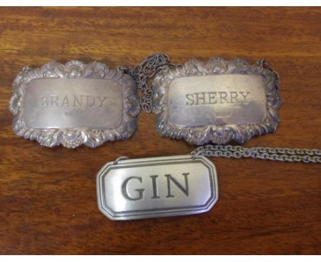Two sterling silver bottle labels & a pewter label