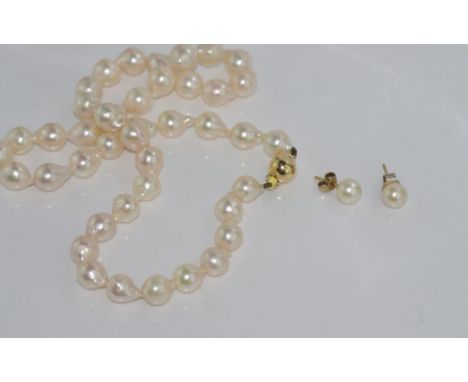 Pearl necklace with slightly baroque pearls and a 14ct gold clasp, together with a pair of pearl earrings (one 9ct clip and o