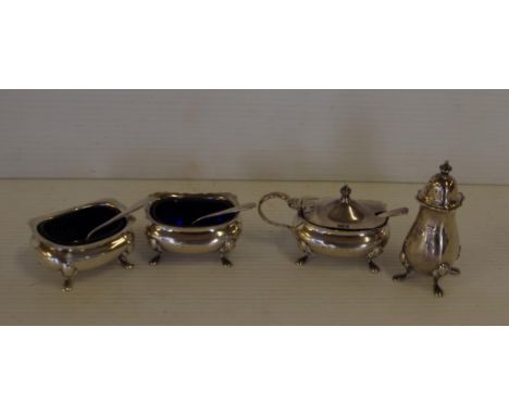Sterling silver cruet set hallmarked Birmingham, comprising of two salt cellars with spoons, pepperette and mustard pot with 