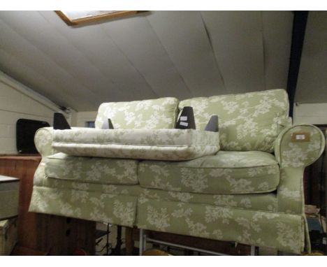 GOOD QUALITY GREEN AND CREAM FLORAL UPHOLSTERED TWO-SEATER SOFA AND RECTANGULAR FOOT STOOL (2)