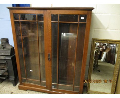 OAK FRAMED TWO GLAZED DOOR ADJUSTABLE SHELF BOOKCASE