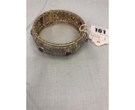 A 10ct diamond and ruby bangle