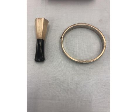 A silver bangle and cheroot holder