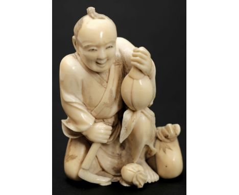 A Japanese carved ivory okimono of a fruit seller: kneeling with axe in one hand and gourd in the other, unsigned, 8cm. high.