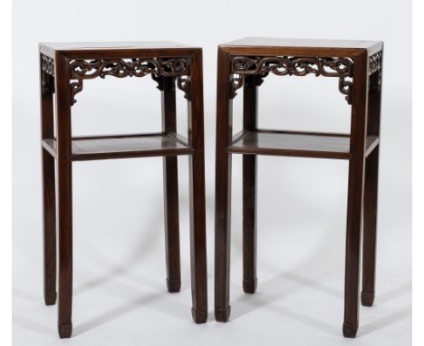 A near pair of Chinese Hua Li wood jardiniere stands:, with plain rectangular tops and pierced scroll aprons, on square secti