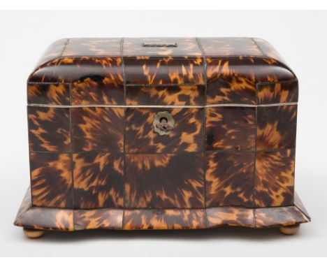 A 19th century blonde tortoiseshell tea caddy: of rectangular outline  with double inverted serpentine front, the hinged lid 