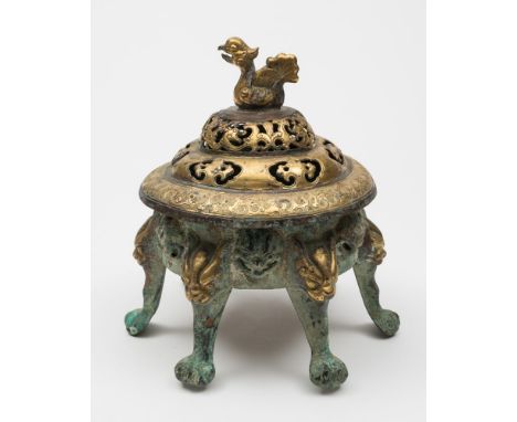 A Chinese gilt-copper incense burner and cover: the pierced cover with bird finial and engraved with writhing dragons, the si