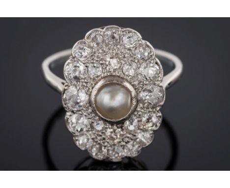 A pearl and diamond oval cluster ring: with central split pearl (untested) approximately 5.8mm diameter pave-set within a sur