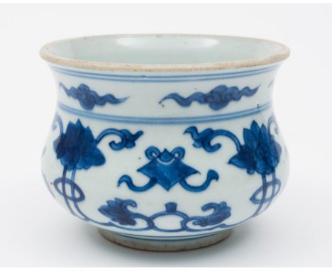 A Chinese porcelain censer: of waisted circular form painted in blue with peony scroll and Buddhist precious objects beneath 