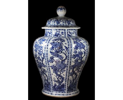 A Chinese octagonal baluster jar and cover: painted in blue with eight panels containing birds and insects among branches of 