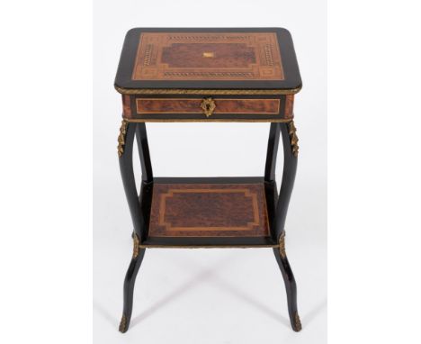 A 19th Century French ebonised, amboyna, inlaid and gilt metal mounted rectangular table:, bordered with boxwood, ebony and h