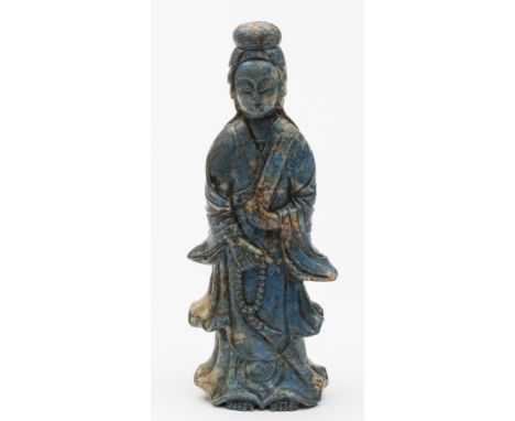 A Chinese carved lapis lazuli figure of Guanyin: wearing flowing robes and holding a scroll in one hand and a bead necklace i