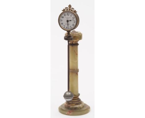 An Edwardian onyx mystery clock: having an eight-day duration timepiece movement set within a swinging pendulum suspended fro