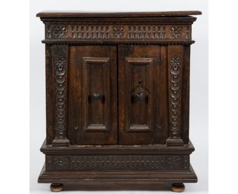 A late 17th/early 18th Century Italian walnut dwarf side cupboard:, the top with a moulded edge, having a dentil, fluted, bea