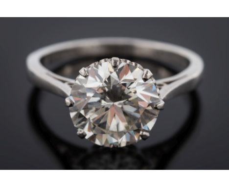 A platinum and diamond single-stone ring: the circular brilliant-cut stone approximately 9.35mm diameter x 5.65mm depth, esti