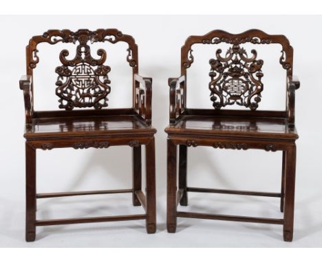 Two similar Chinese carved Hua Li wood armchairs:, the backs with shaped top rails decorated with cloud bands and central pie