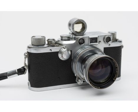 A Leica III 35mm camera, serial No 428583: with Summitar f = 5cm. 1:2 No 627815 lens, with black and chrome body.

