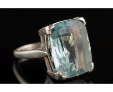 A rectangular aquamarine single-stone ring: the cushion-shaped aquamarine approximately 16.4mm long x 13.5mm wide in four-cla