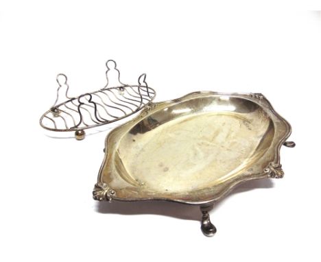 A SILVER ASPARAGUS TRAY by Hutton & Sons, Sheffield 1922, the oval shaped tray with shell motifs at the compass points, with 