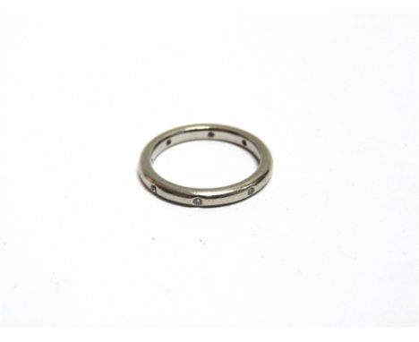 A DIAMOND SET WEDDING RING unmarked, the eight brilliant cuts estimated as totalling approximately 0.04 carats, finger size K