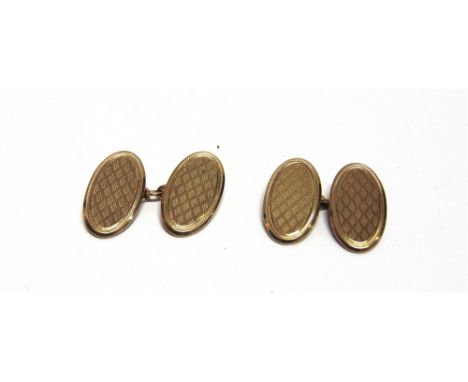 A PAIR OF 9 CARAT GOLD CUFFLINKS  Chester 1929? Date letter rubbed, the oval engine turned panels with chain connectors, 11g 